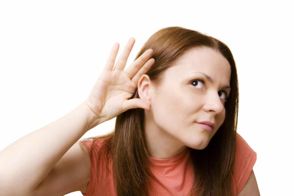 woman cupping hear because she cannot hear