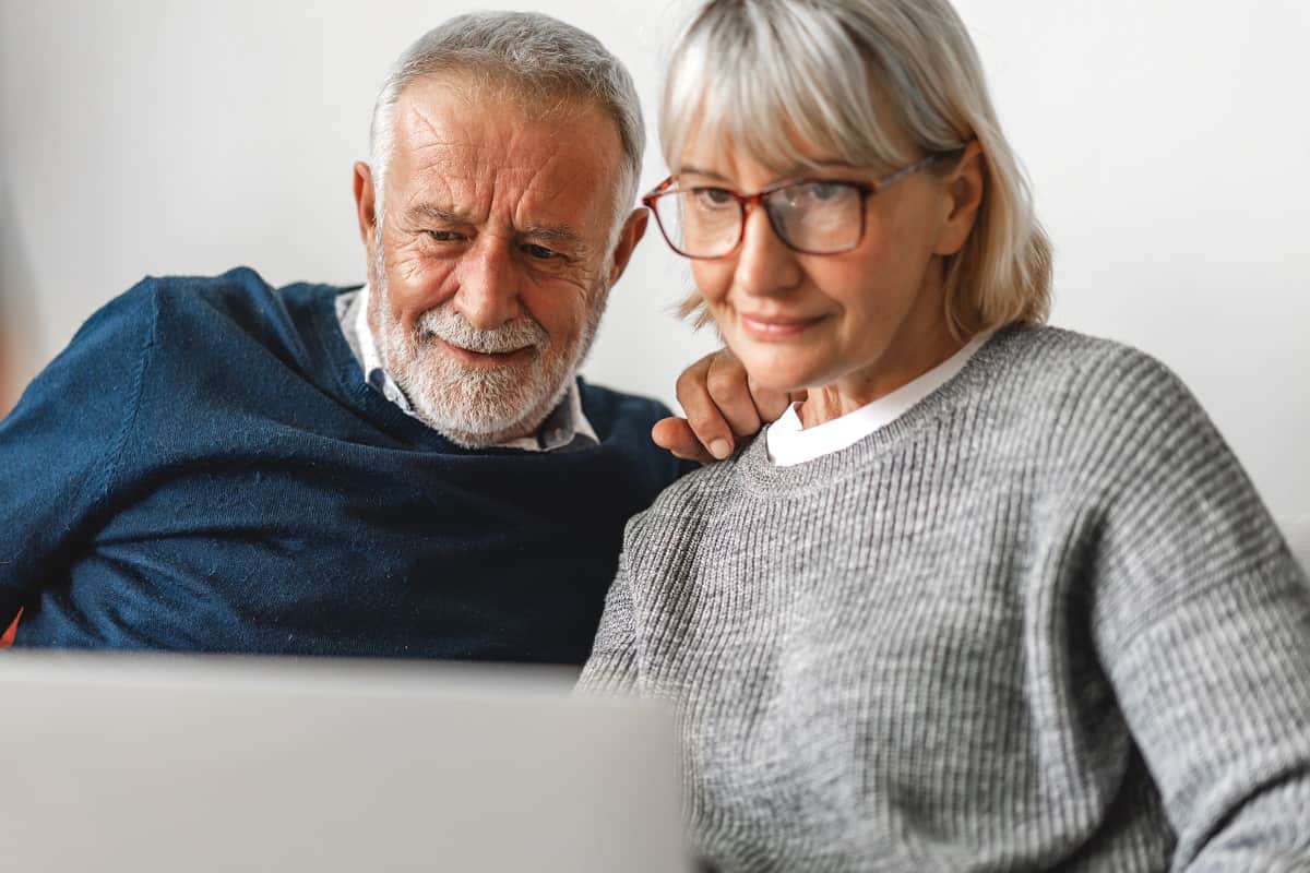 senior couple looking at laptop together